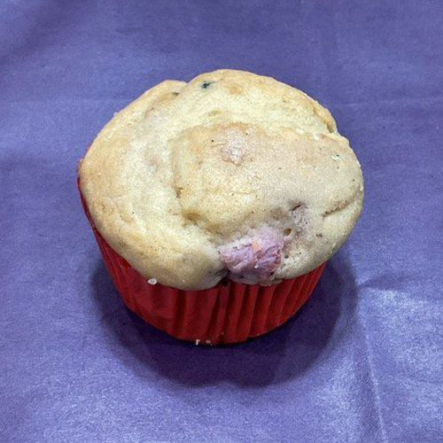 A muffin sitting on top of a purple table.
