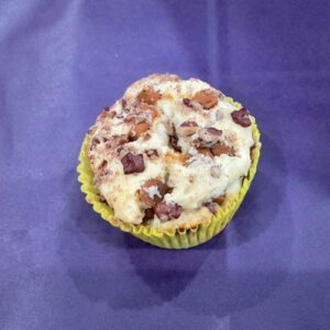 A muffin with some kind of cheese on top