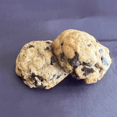 Two cookies are sitting on a table.