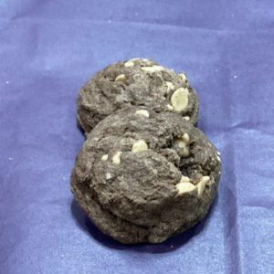 A close up of two cookies on top of a blue surface