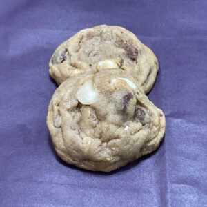 A close up of two cookies on top of purple paper.