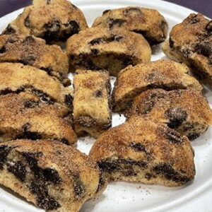 A white plate topped with lots of chocolate chip cookies.