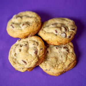 Chocolate chip cookies on a purple background.