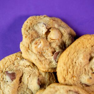 Chocolate chip cookies on a purple background.