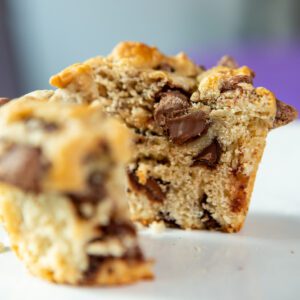 Chocolate chip muffin with a bite taken.