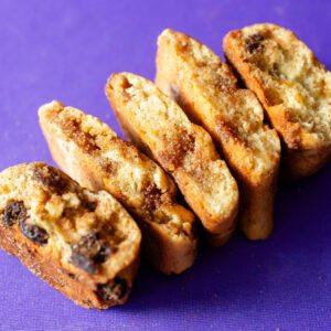 Sliced cookies arranged on a purple surface.